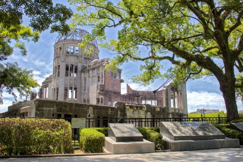 A view of the Atomic Bomb Dome with large, memorial plaque stones