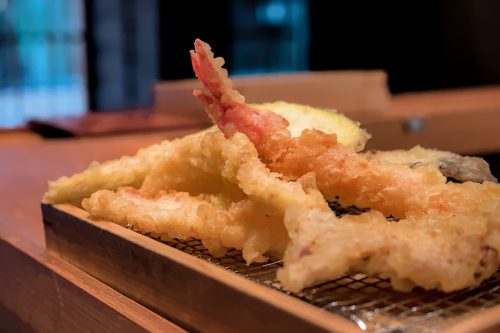 A variety of crispy-looking tempura on a wire cooling rack