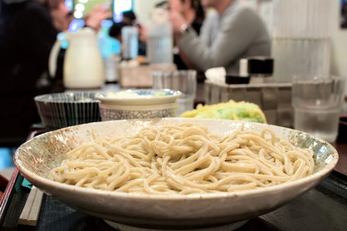 A ceramic plate of plain, cold soba noodles