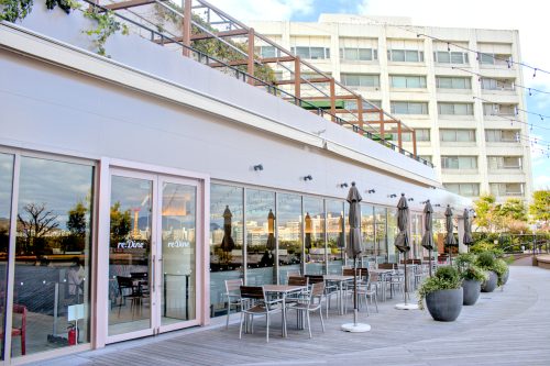 The sun sets in the windows of the outdoor patio next to reDine Hiroshima