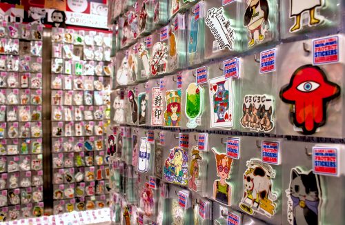 More walls covered with racks of stickers for sale