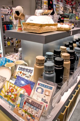 A shop display of water bottles, postcards, toys and tableware decorated with B-SIDE LABEL designs