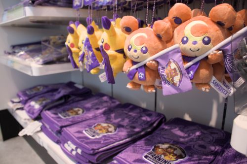 Plush charms, Teddiursa and Pikachu, hold purple flags supporting Sanfrecce Hiroshima.