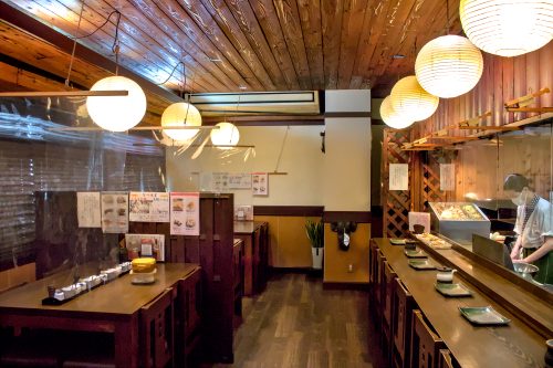 Wood paneling and paper lanterns inside Tempura Shokudo Tamaru