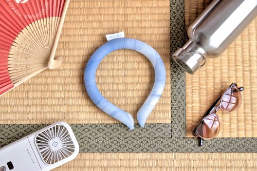 A blue and white mottled plastic ring with an opening at one end. It is laid on a tatami mat.