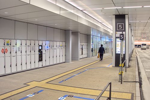 Lockers next to a bus platform inside a building